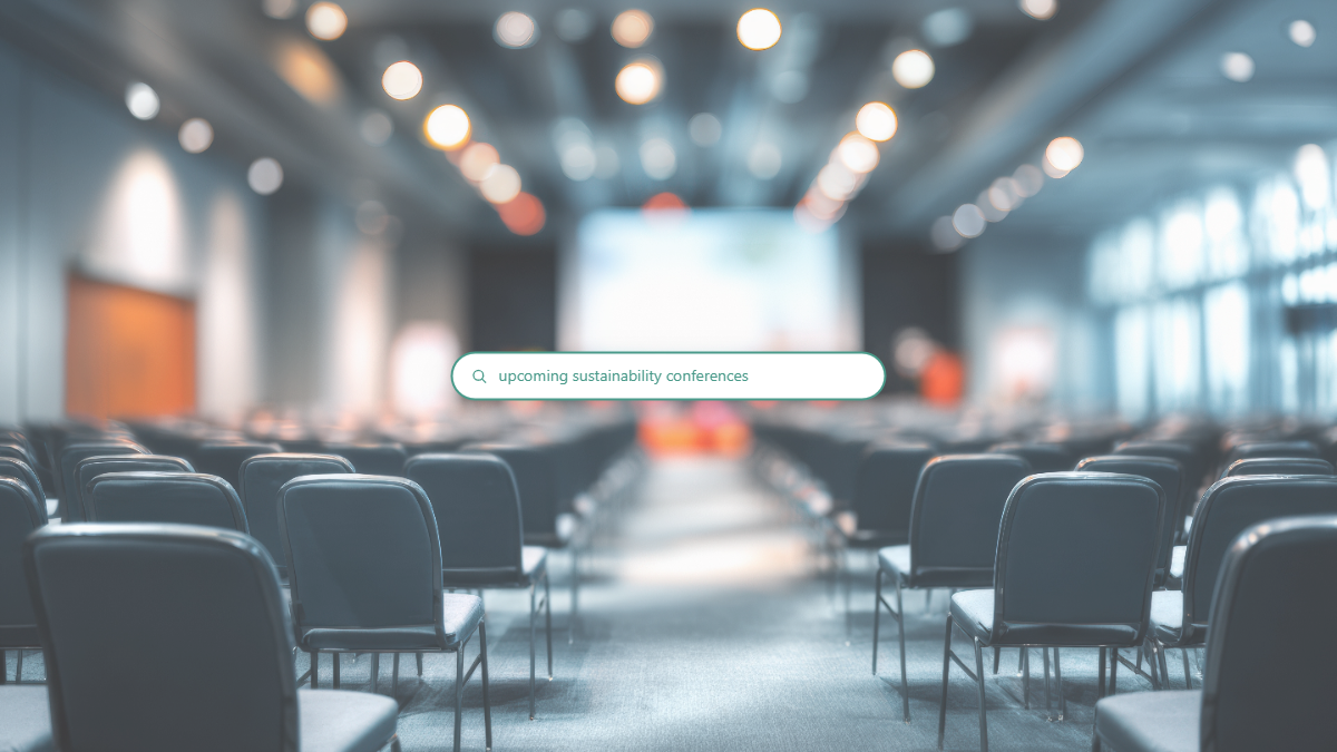 A search bar reading 'upcoming sustainability conferences' over a softly blurred conference hall.